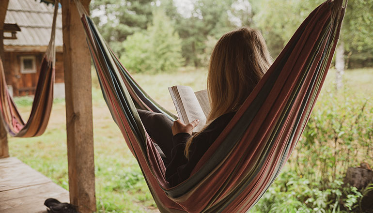 woman on hammock reading a book